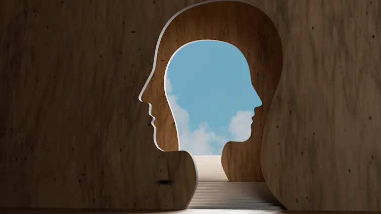 steps leading through a head to a bright sky