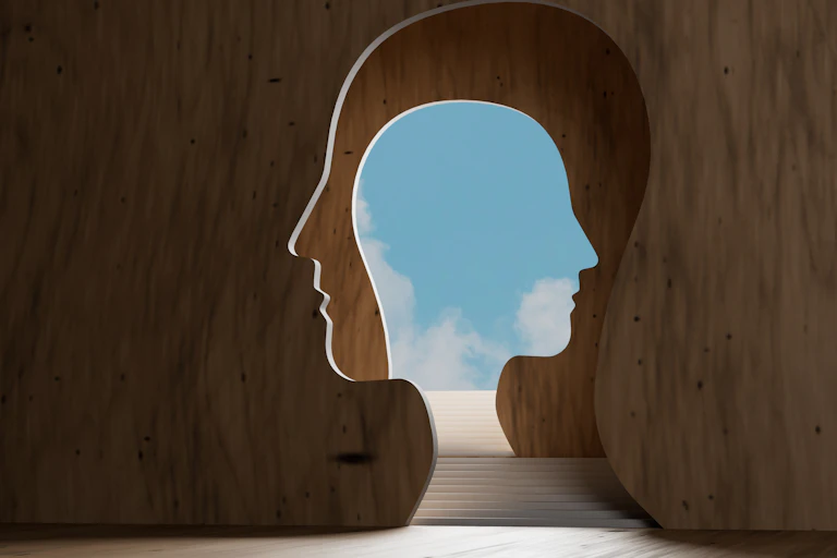 steps leading through a head to a bright sky
