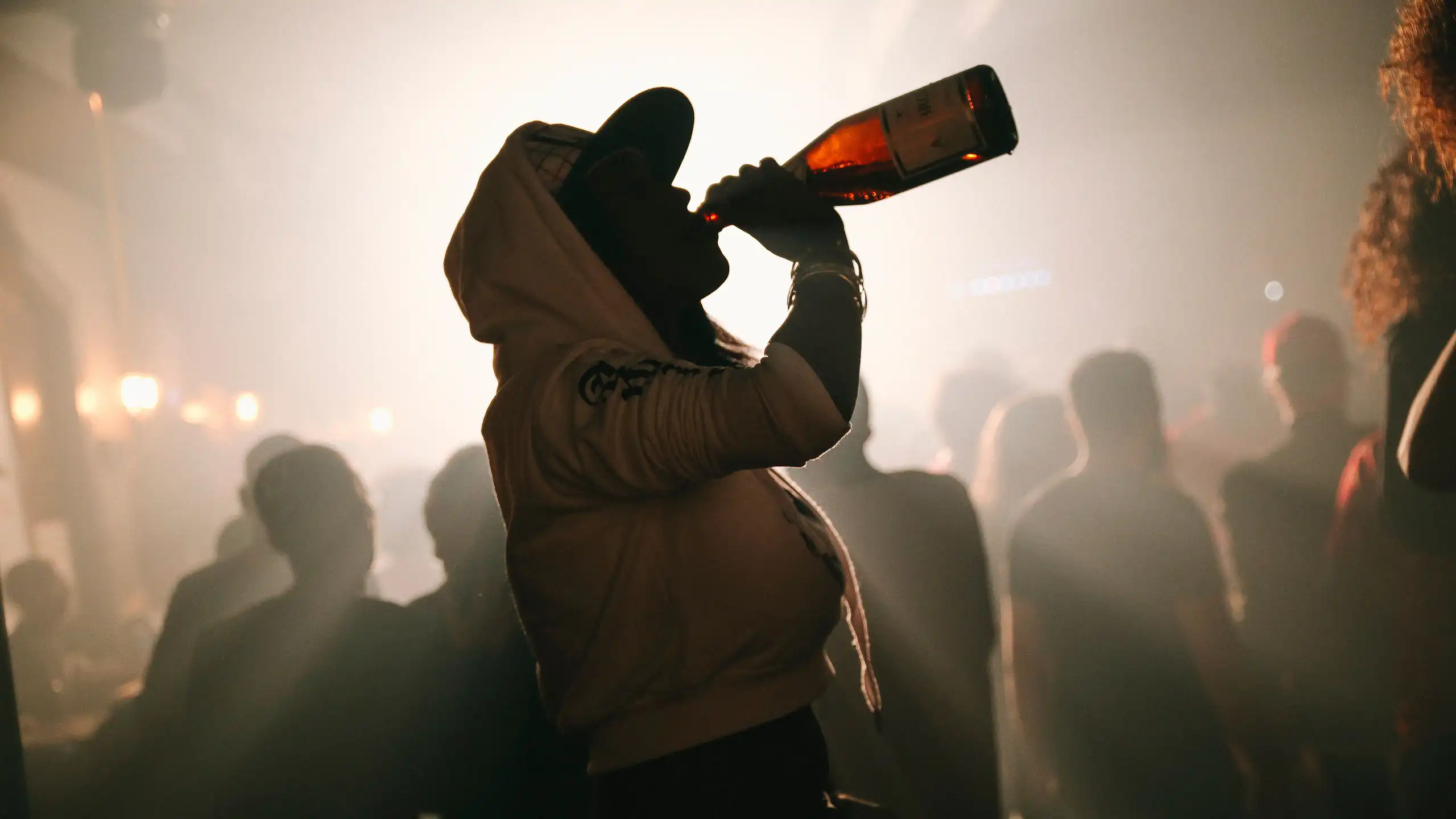 Woman drinking wine from the bottle