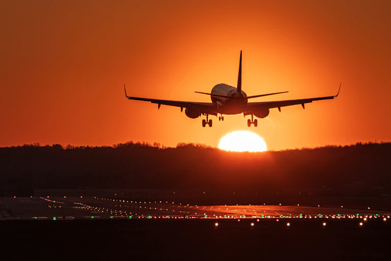 Plane landing at sunset.