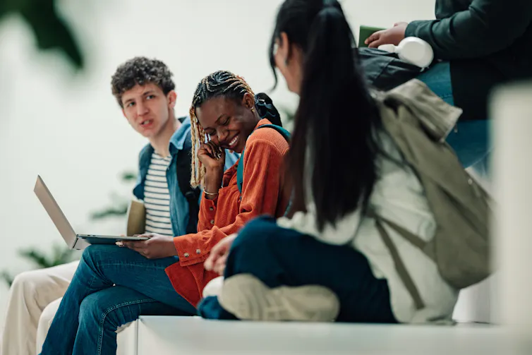 Group of teens sat on steps