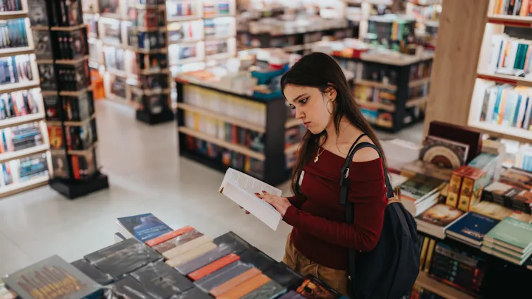 Young woman browsing for books.