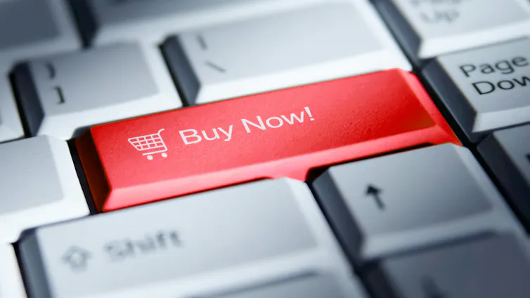 A photo image shows a bright red 'buy now' button on a computer keyboard.