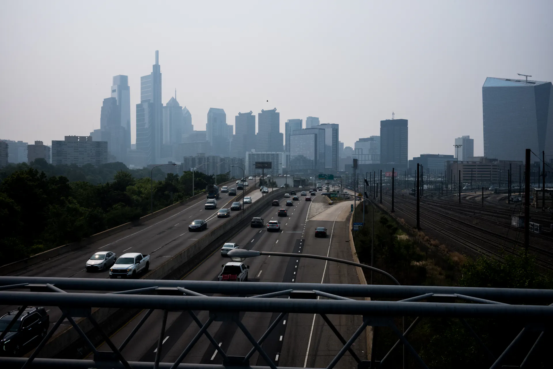 View of smoggy urban skyline in backgorund and highway in foreground
