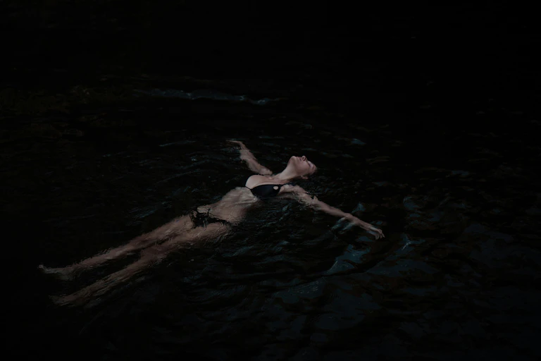 a woman in water at night