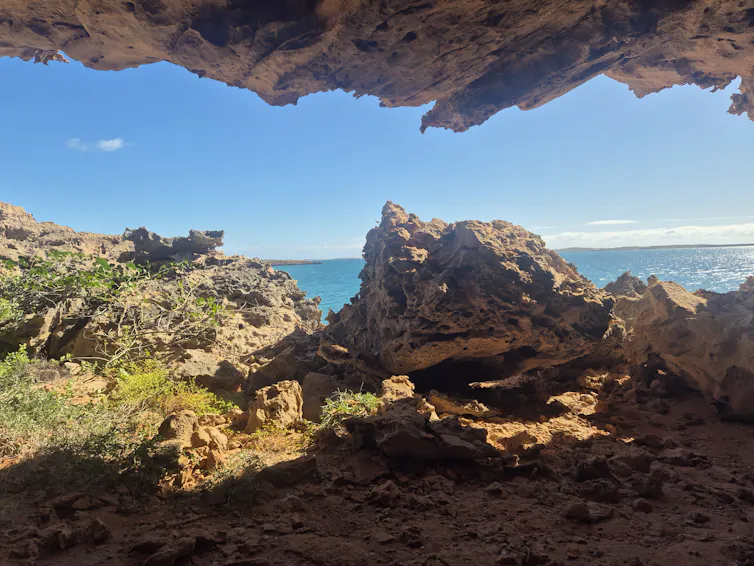 inside a cave, looking onto ocean