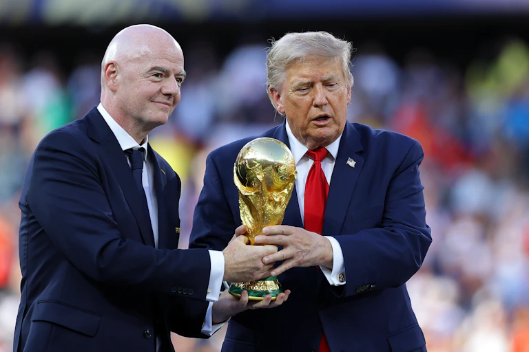 FIFA president Gianni Infantino and US president Donald Trump hand over the trophy to Spain.