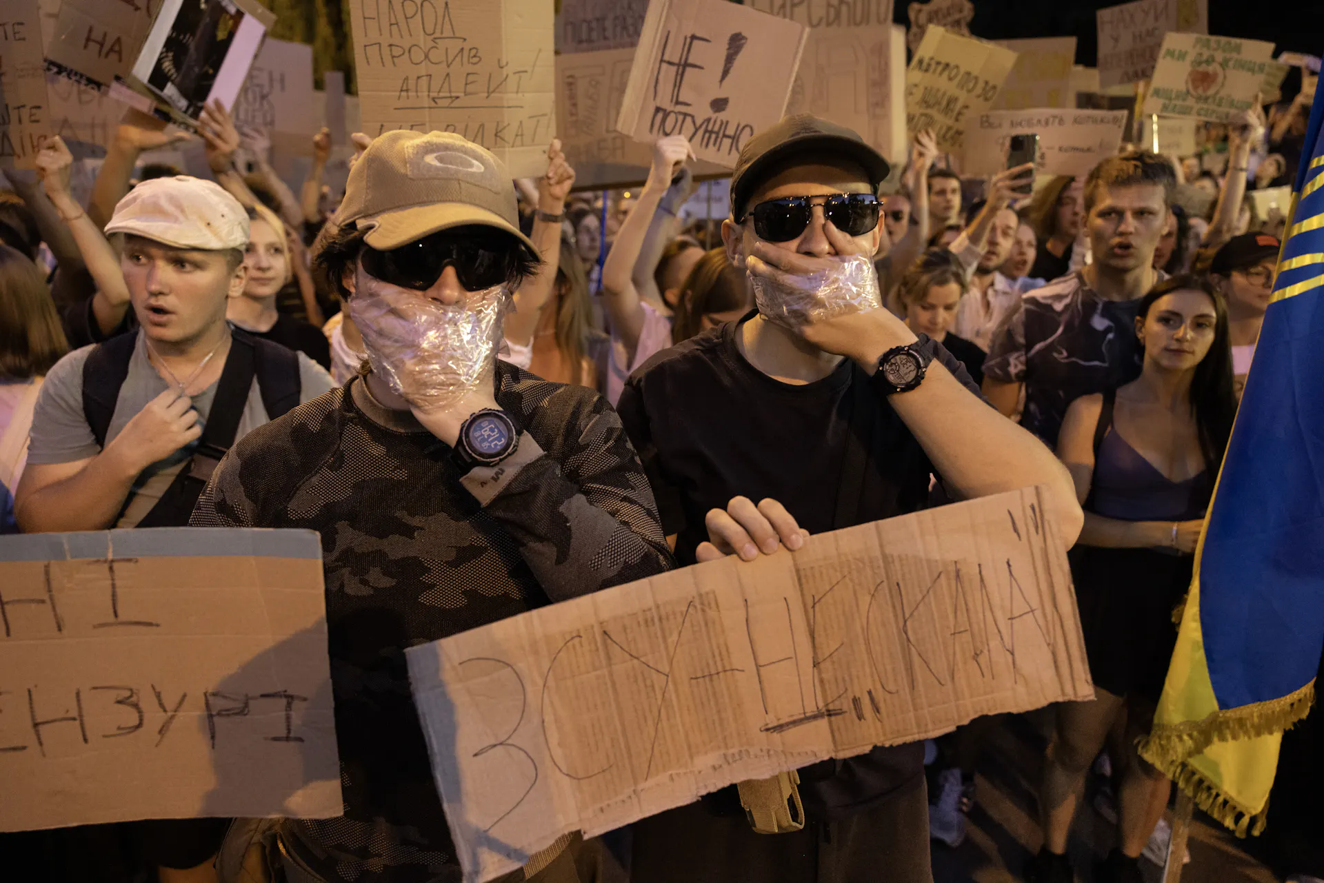 Protestrs cover their mouths with their hands