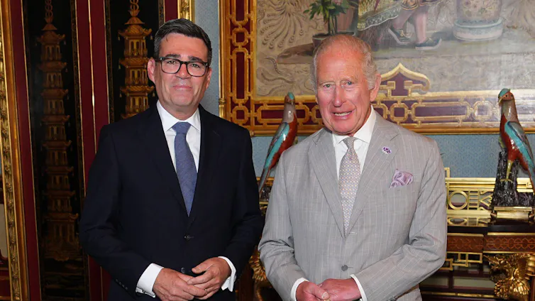 andy burnham standing alongside king charles inside buckingham palace.