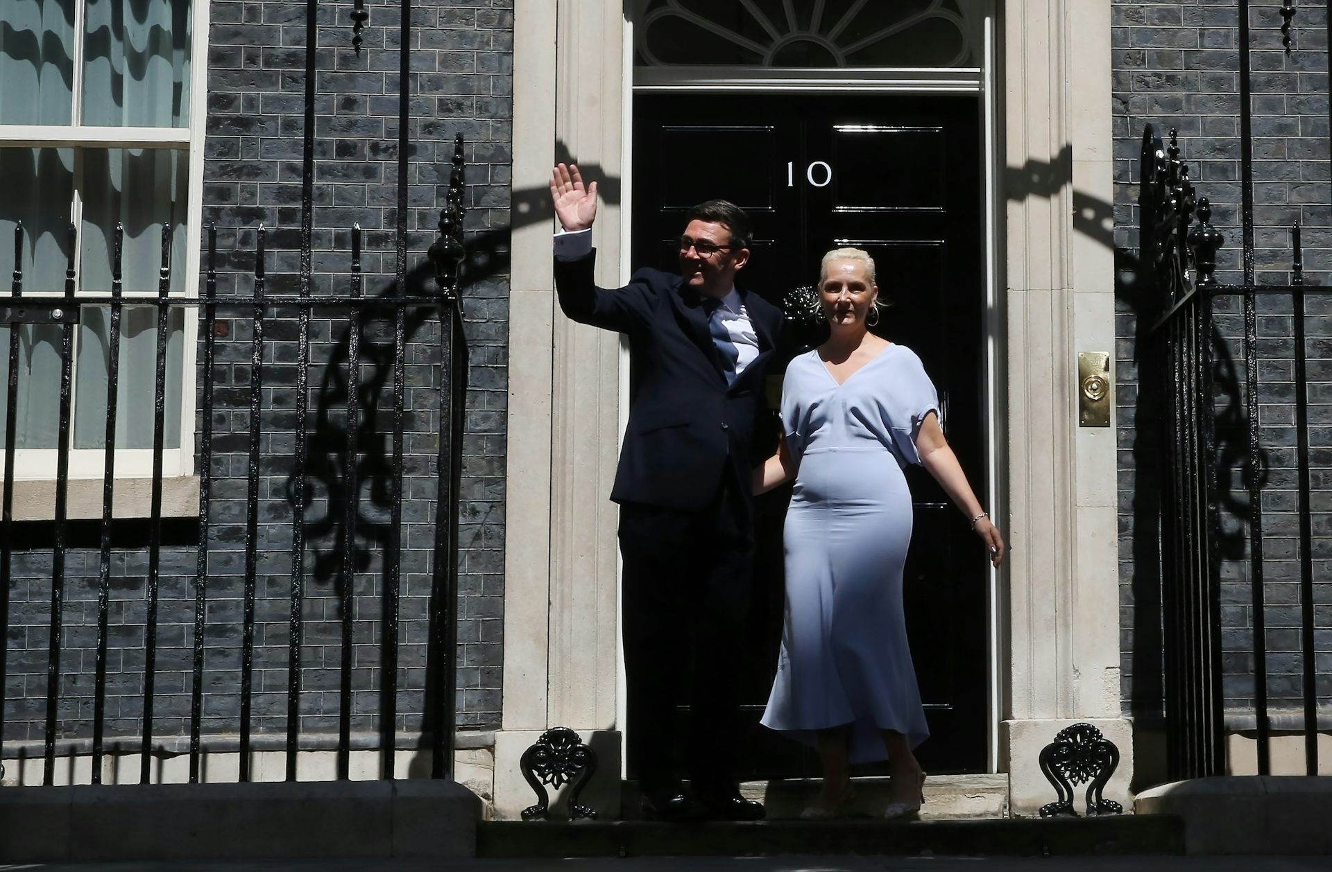 andy burnham and his wife on the steps of 10 downing street shortly after he became prime minister.
