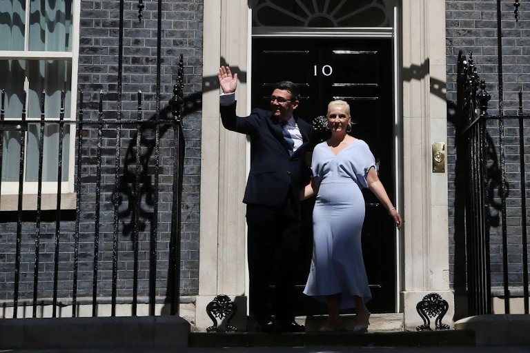 andy burnham and his wife on the steps of 10 downing street shortly after he became prime minister.