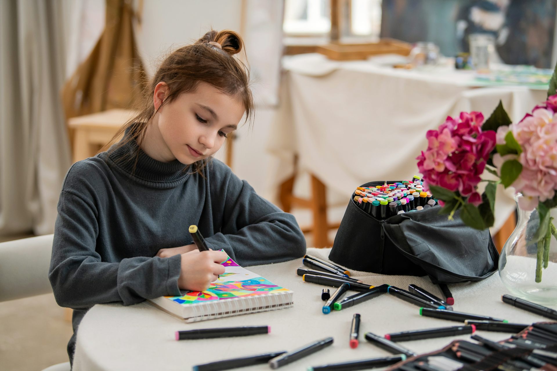 Girl drawing with coloured pens