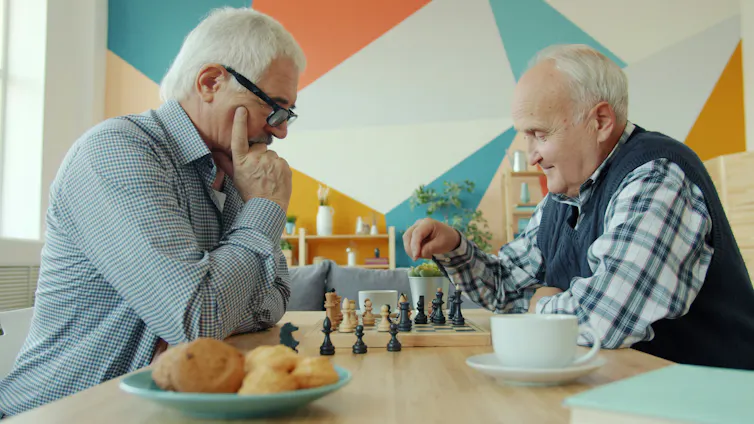 Two elderly men playing chess