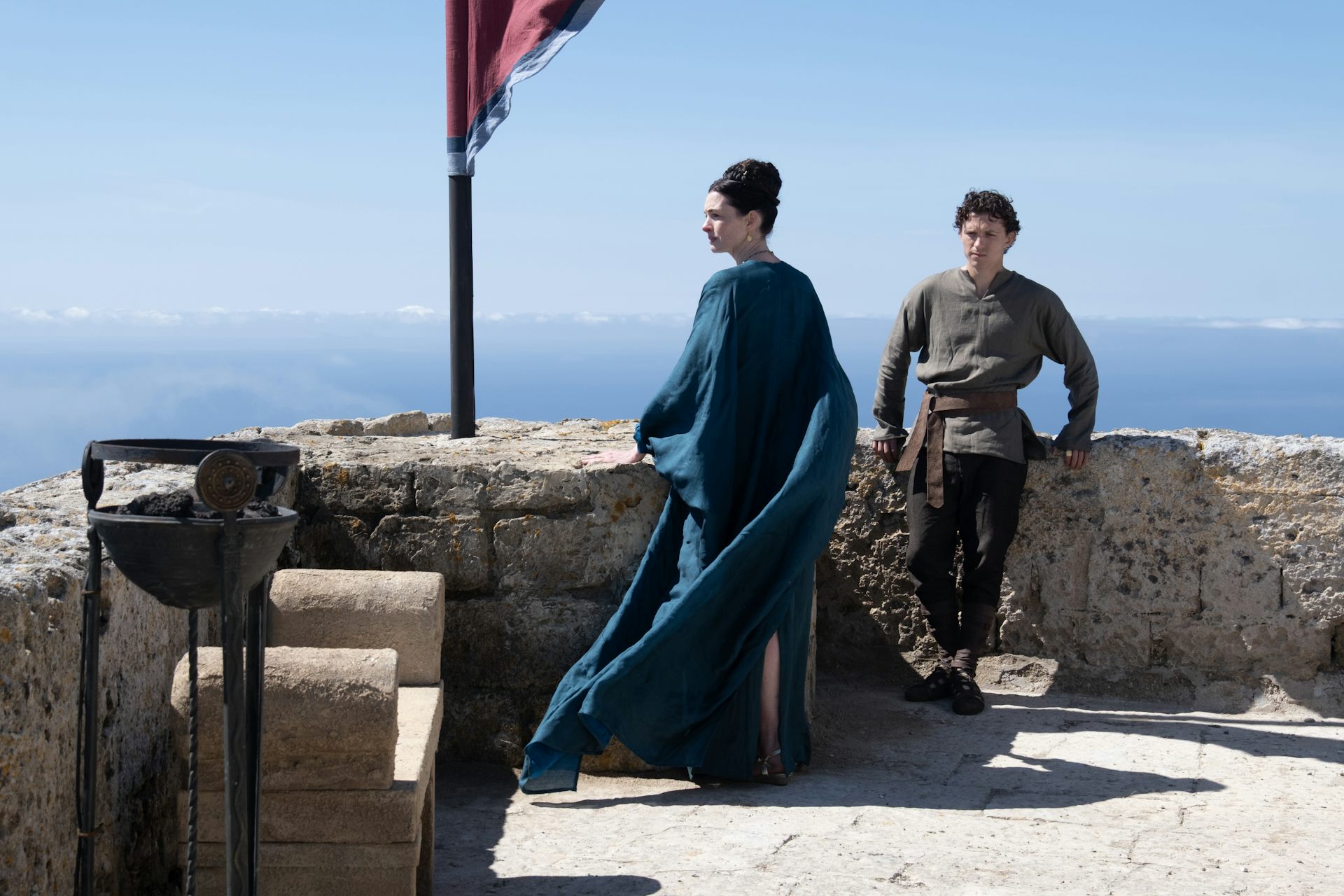L to R: Anne Hathaway is Penelope and Tom Holland is Telemachus in The Odyssey, written, produced, and directed by Christopher Nolan.