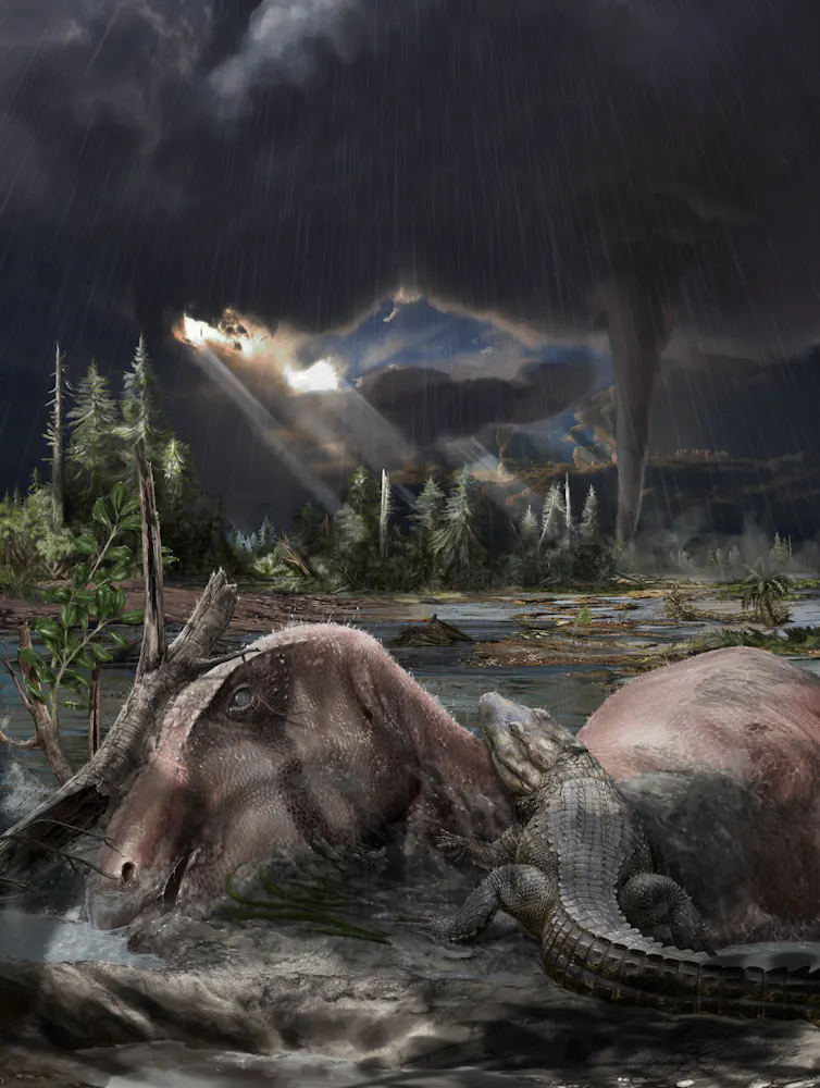The artwork shows a carcass of the dinosaur Tethyshadros insularis and an Acynodon crocodyliform on a storm-swept tropical tidal flat, beneath the monsoon clouds and a distant cyclone