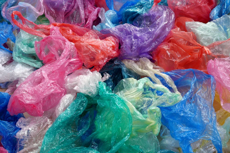 blue green pink white plastic bags in pile