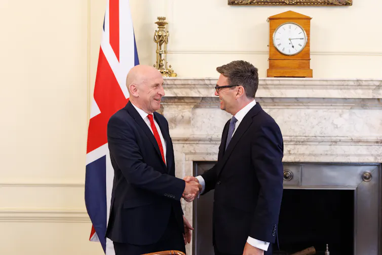 andy burnham shaking hands with john healey in the cabinet office in 10 downing street.