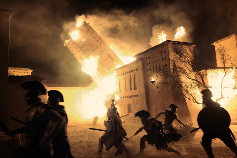Burning buildings and Greek soldiers.