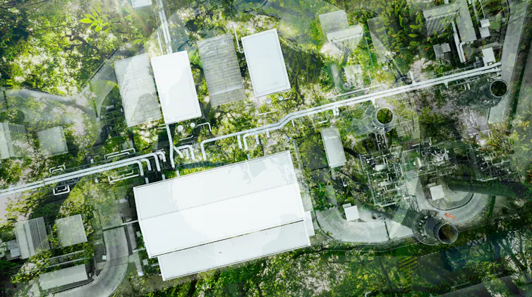 aerial shot of factory, surrounded by green land