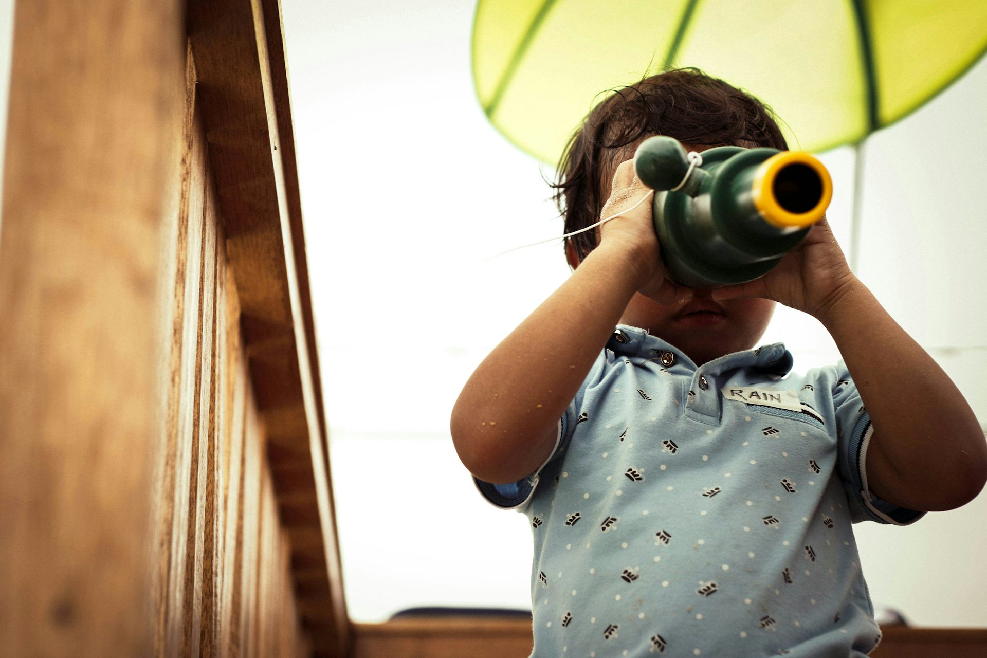 A child peers through a kaleidescope.