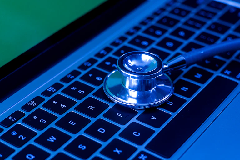 the end of a stethoscope on a laptop keyboard