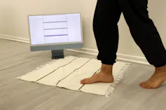 A woven area rug showing the sensor activity on a computer screen when someone is stepping on it.