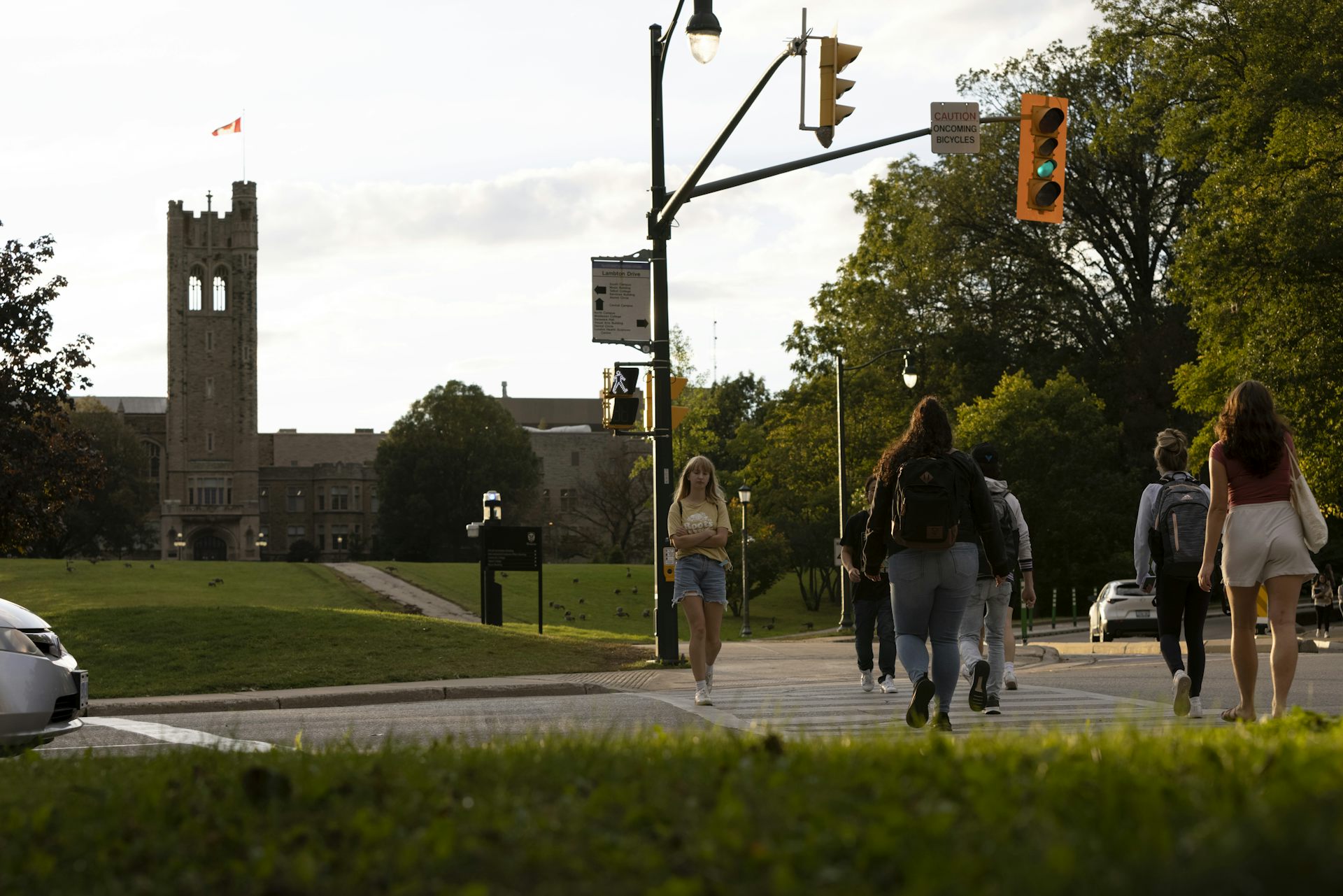 University students cross the street in front of a campus building