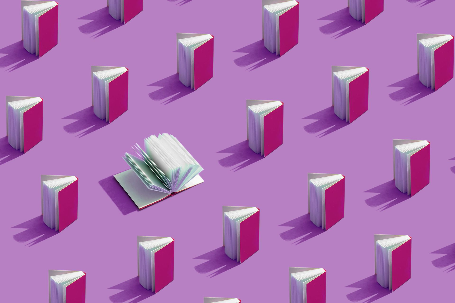 pink books against a bright purple background