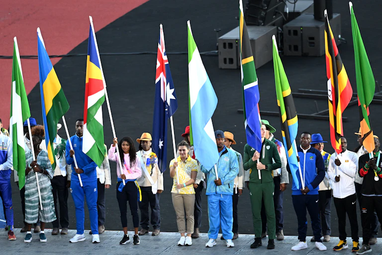 People from various Commonwealth countries hold flags