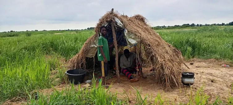A farmer and his son resting in their hut located in their farm in Benue State, Nigeria.