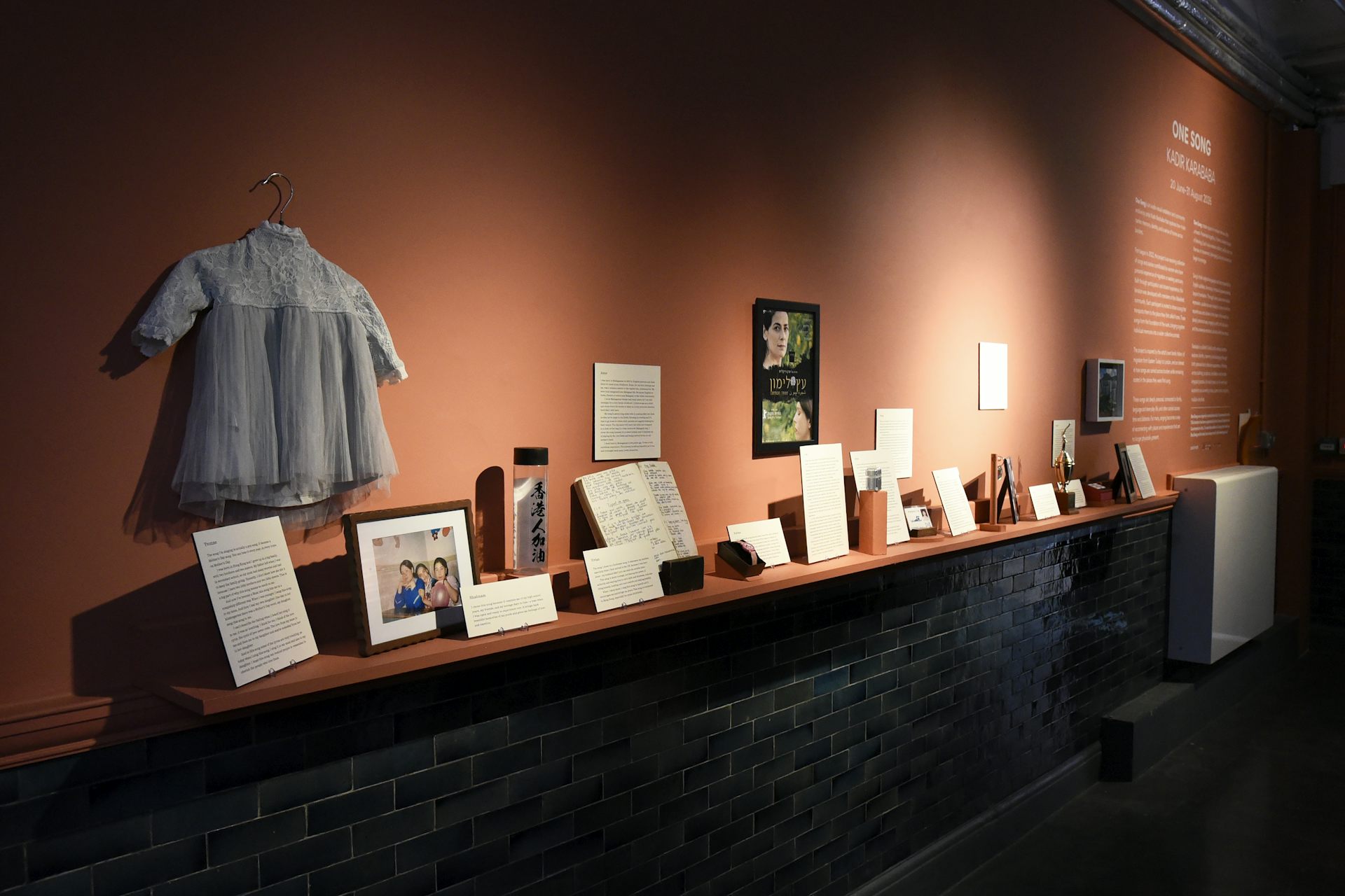 Objects on display in the exhibition including clothing and books.