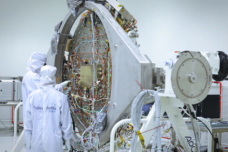 Two engineers standing in front of equipment from the ExoMars programme.