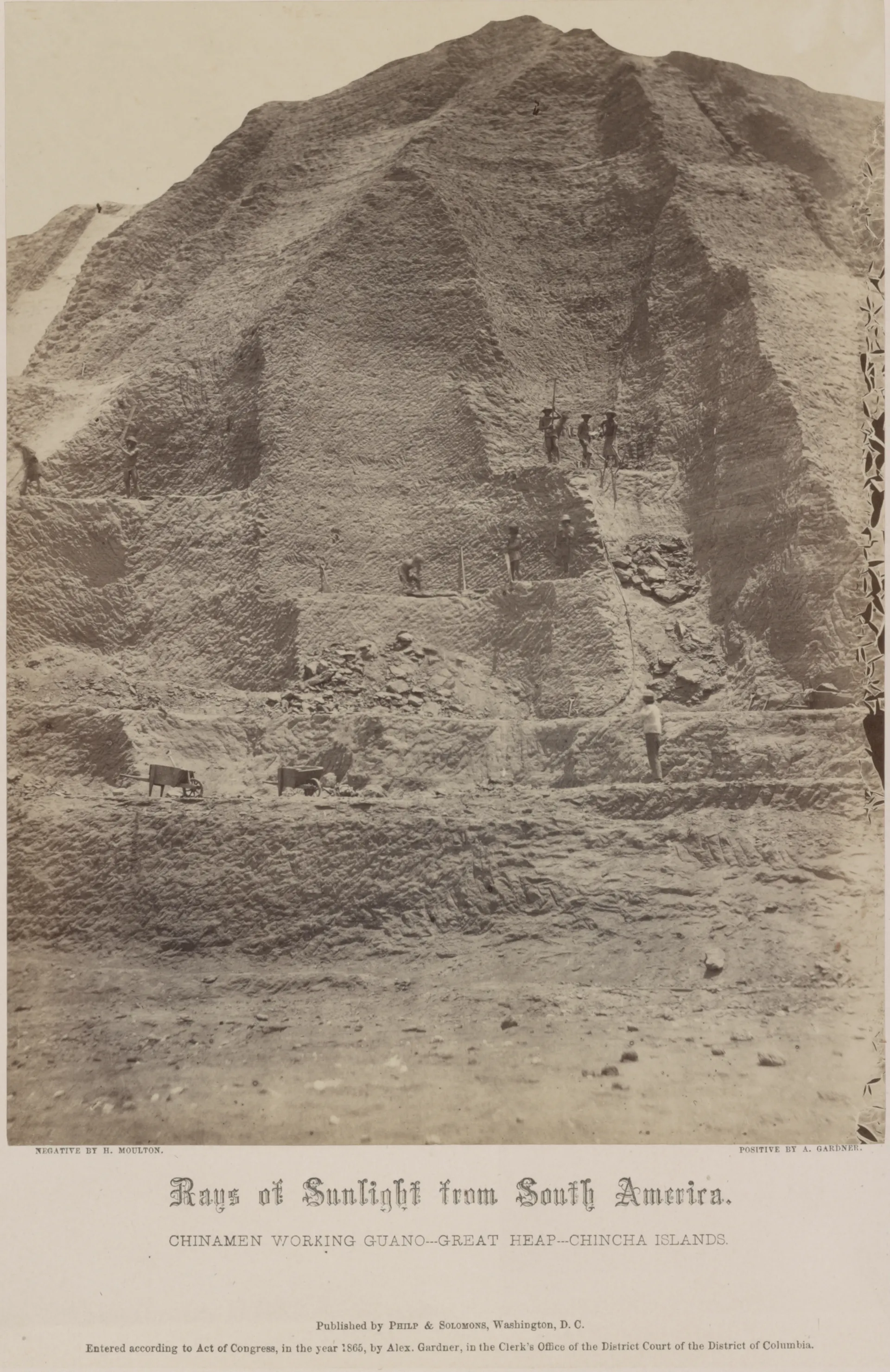 Human figures are visible against a tall mound of material.