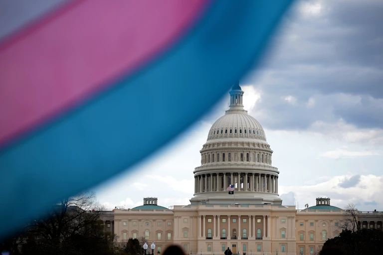 The U.S. Capitol is seen behind a transgender pride flag