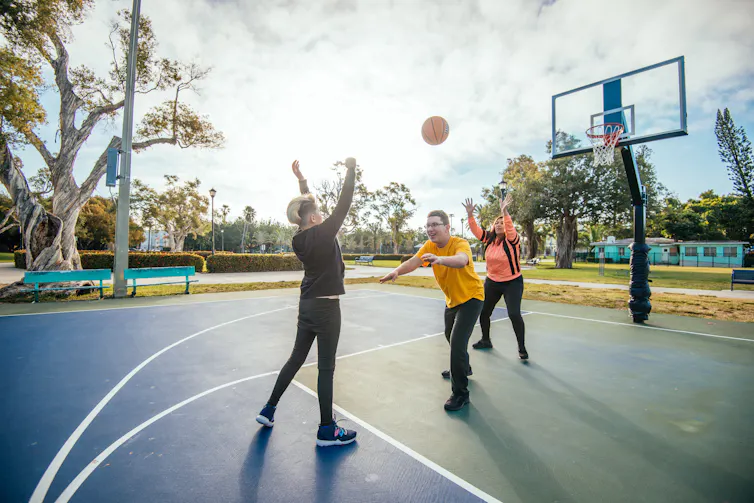 kids playing basketball at a park