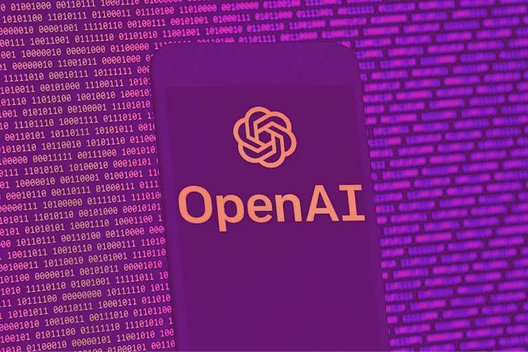 A mobile phone screen displaying the OpenAI logo, in front of a background of ones and zeroes.