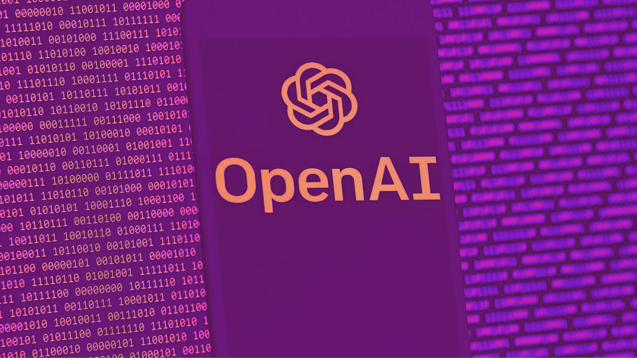 A mobile phone screen displaying the OpenAI logo, in front of a background of ones and zeroes.