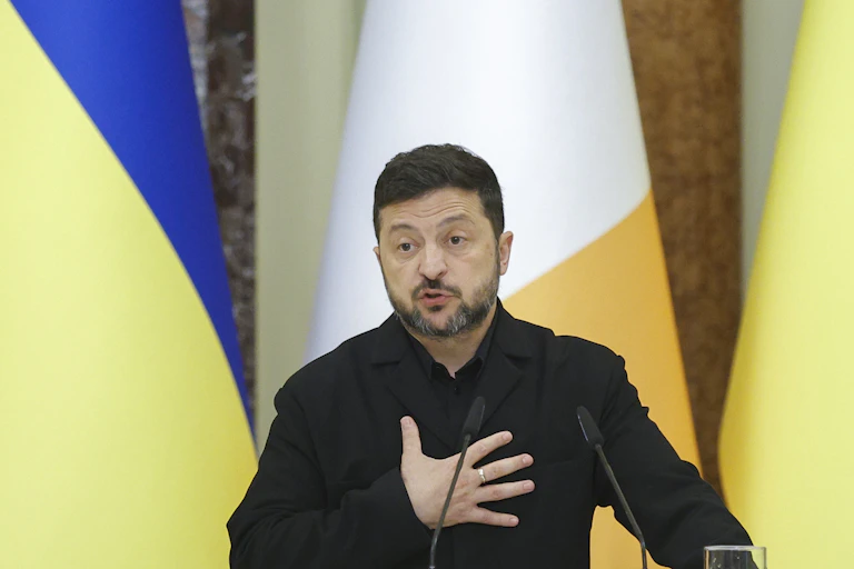 The Ukrainian president, Volodymyr Zelensky, places his hand on his heart during a press conference, July 23 2026.