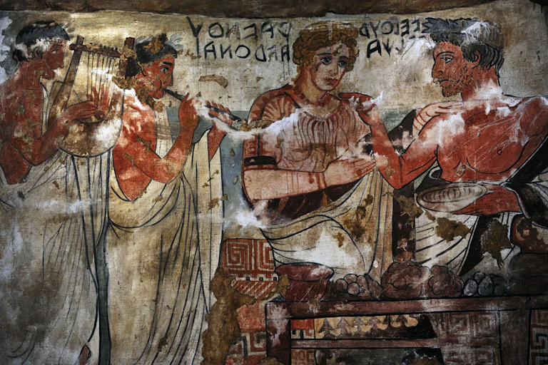 An inscription in Etruscan hangs above the heads of a noble couple in this fresco from the Tomb of the Shields, Tarquinia, Italy.
