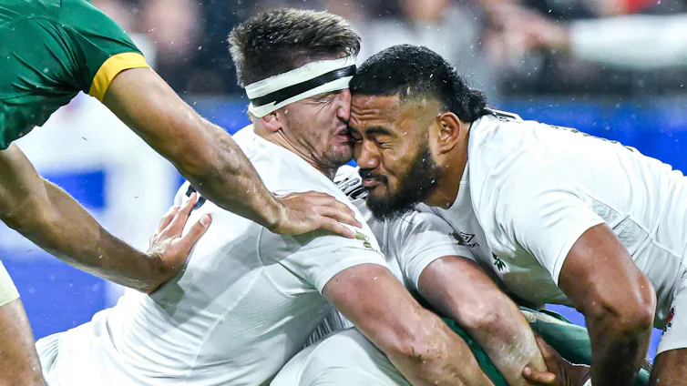 Close-up of the heads of two rugby players colliding during a match