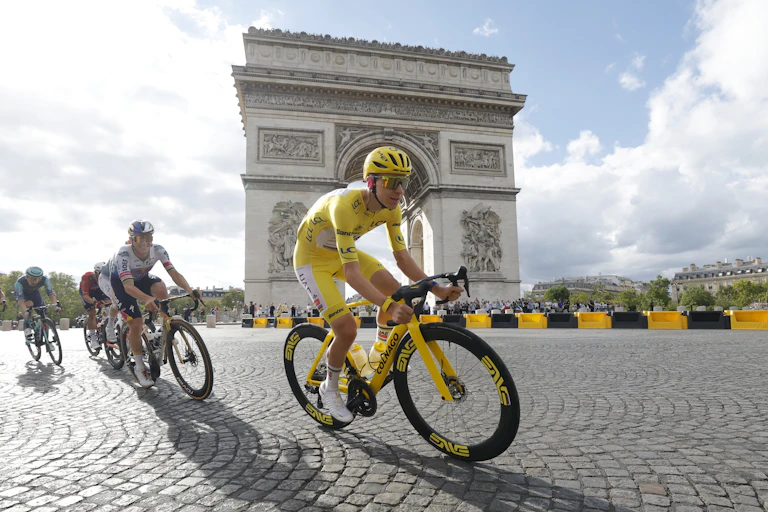 Tadej Pogacar rides in front of the Arc de Triomphe during the final stage of the Tour de France.