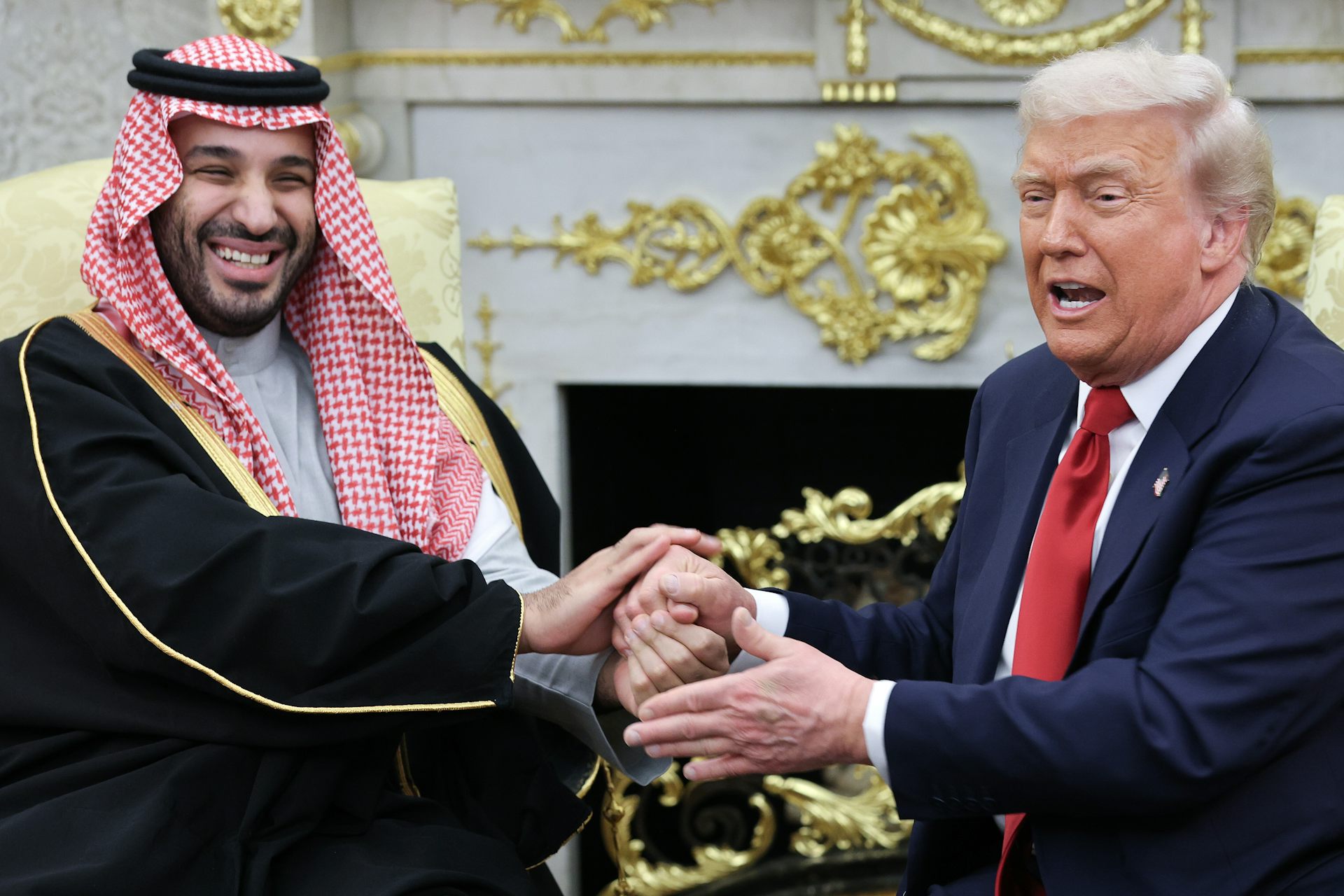 Two men shake hands.