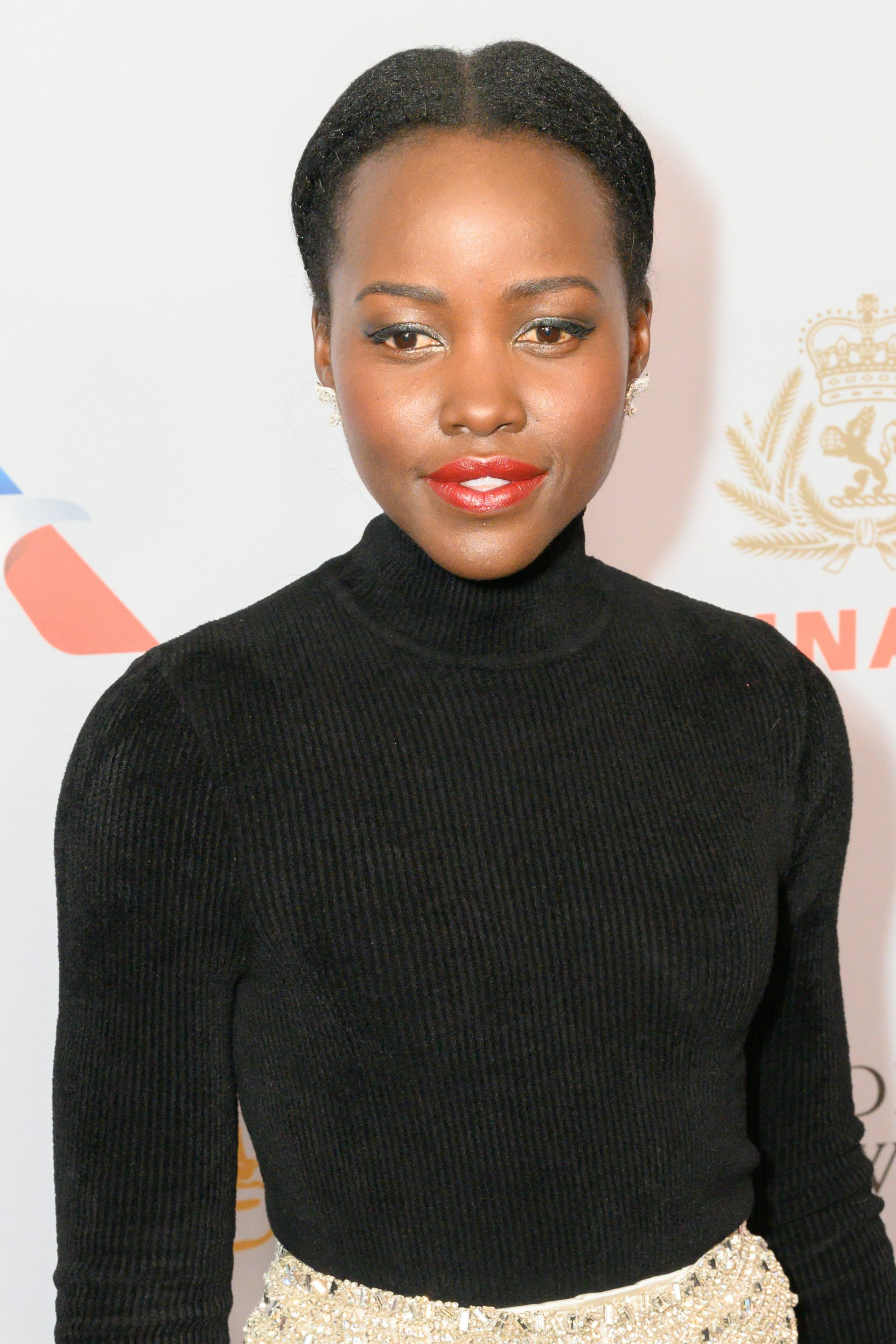 A young woman dressed in a black polo neck.