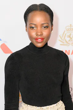 A young woman dressed in a black polo neck.