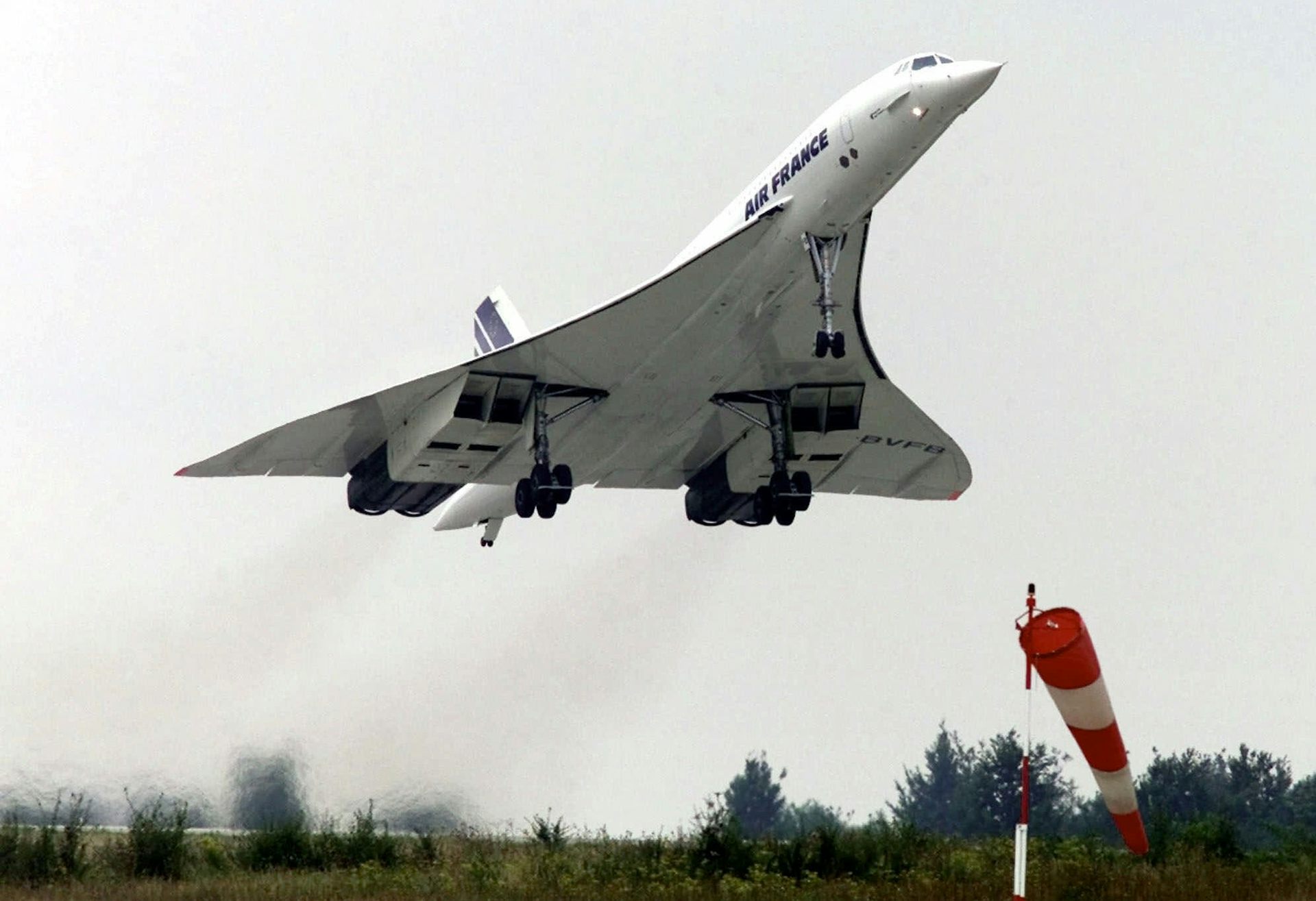 A photo showing a jet with a triangular shape taking off