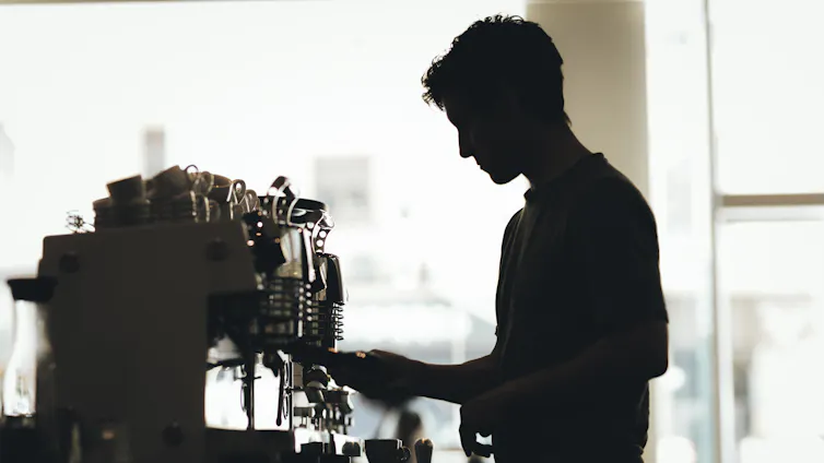 Silhouette of a barista preparing coffee