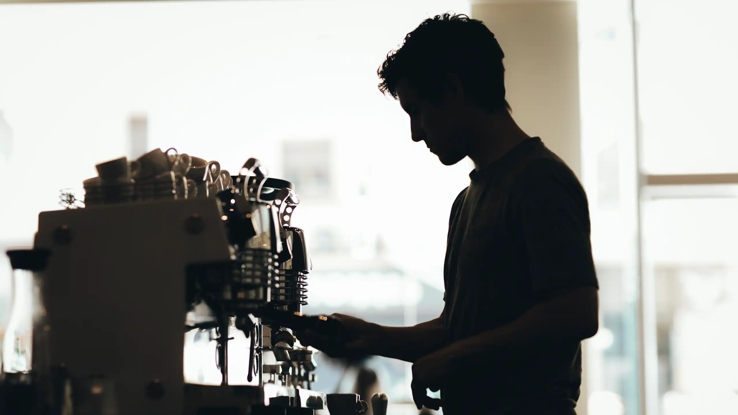 Silhouette of a barista preparing coffee
