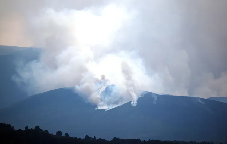 smoke from fire in dark mountains