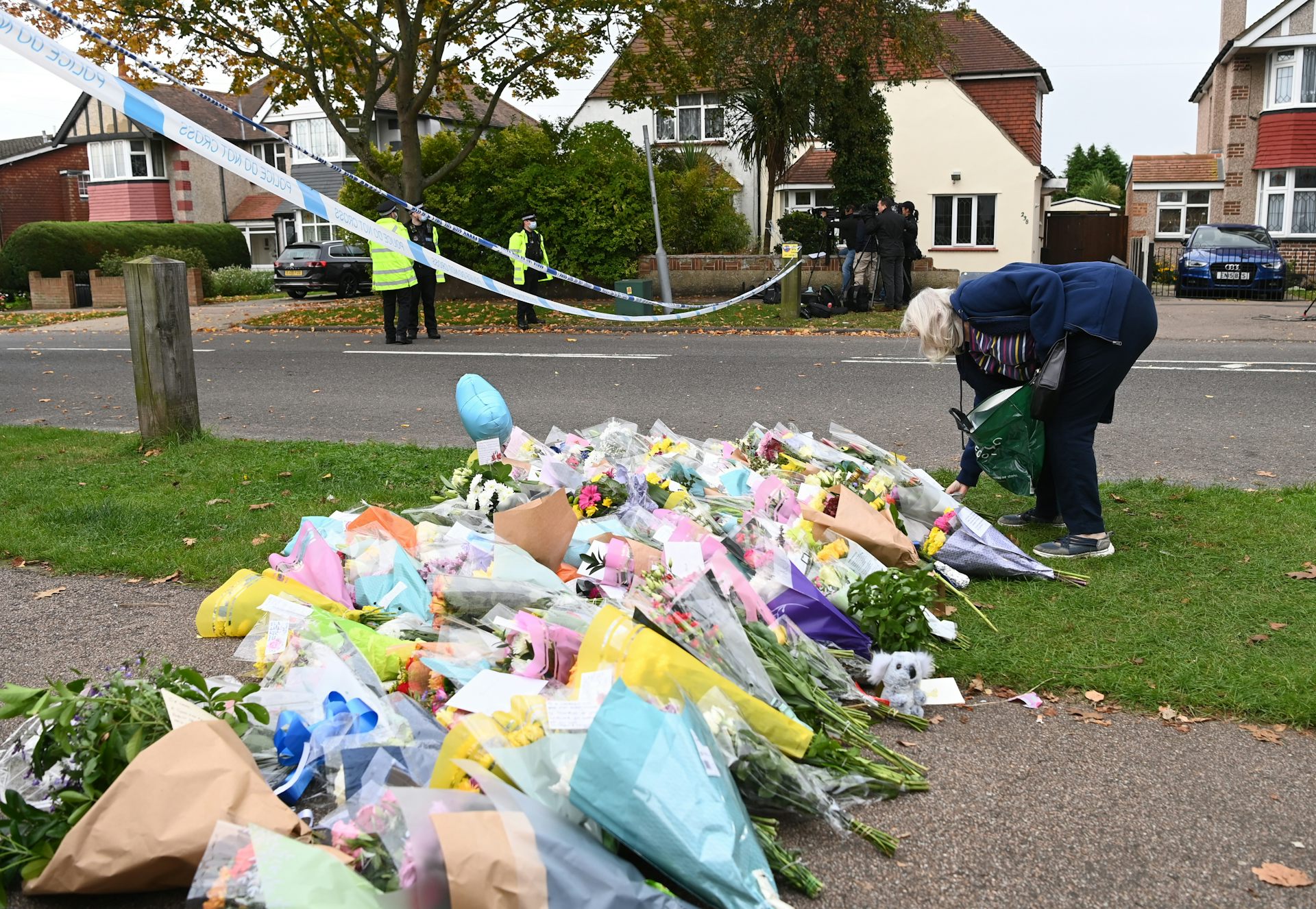 A woman with flowers at the spot where MP David Amess,was stabbed to death in Leigh-on-Sea in October 2021.