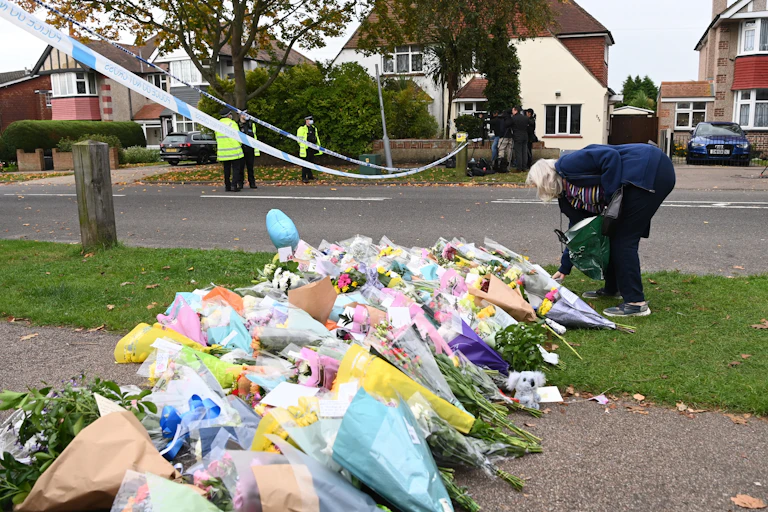 A woman with flowers at the spot where MP David Amess,was stabbed to death in Leigh-on-Sea in October 2021.